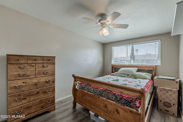 bedroom featuring dark wood-type flooring, ceiling fan, and baseboards