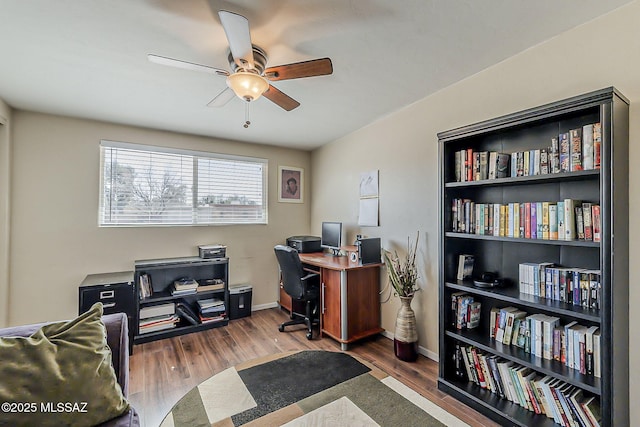 office space featuring ceiling fan, baseboards, and wood finished floors