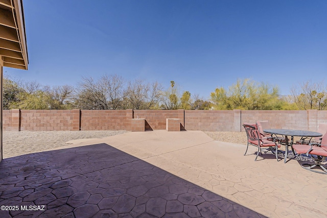 view of patio featuring outdoor dining space and a fenced backyard