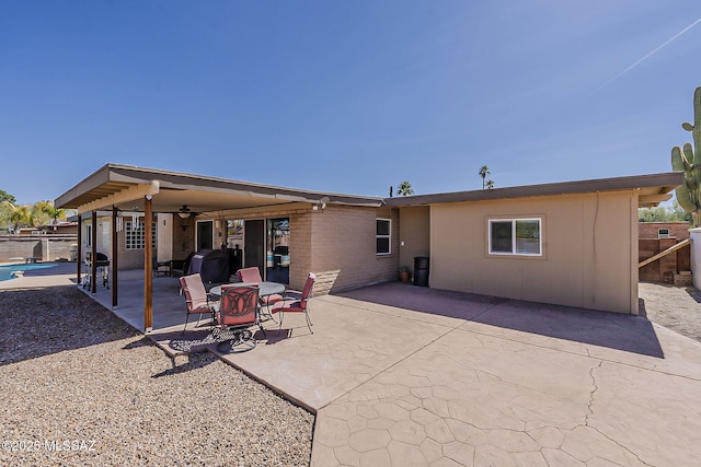 rear view of house with a patio area, fence, and a ceiling fan