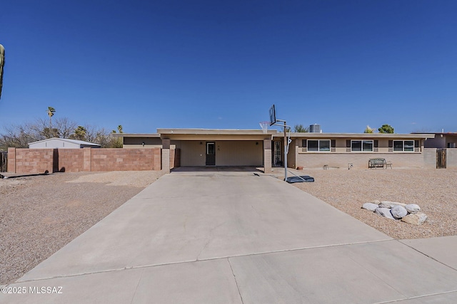 view of front of house featuring driveway and fence