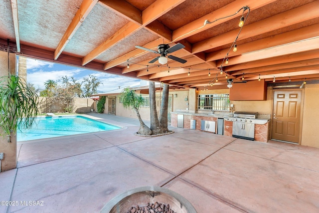 view of pool featuring a fenced in pool, a patio, ceiling fan, fence, and exterior kitchen