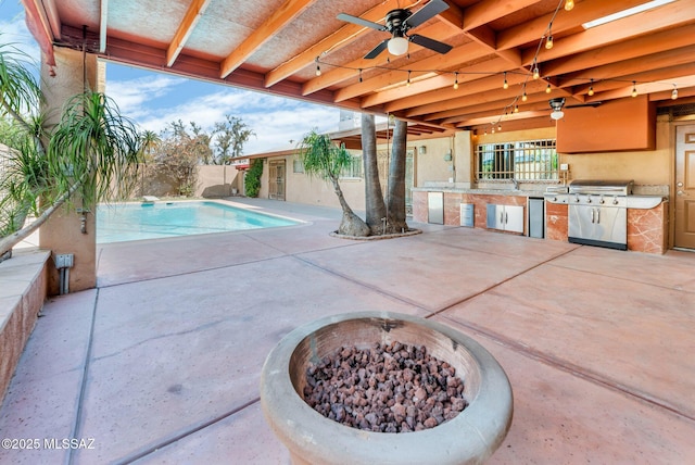 view of swimming pool featuring area for grilling, fence, a ceiling fan, grilling area, and a patio area