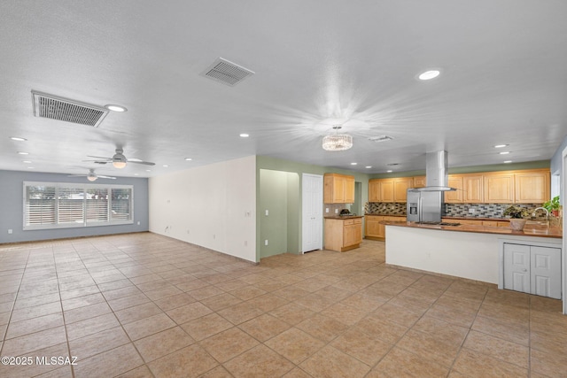 kitchen featuring open floor plan, visible vents, and island range hood