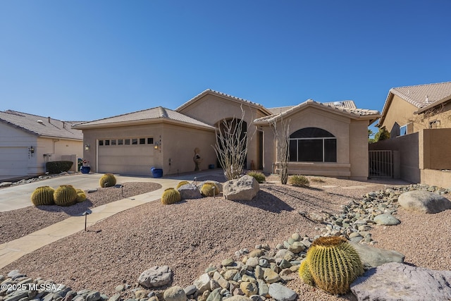 view of front facade featuring concrete driveway, a tile roof, and stucco siding