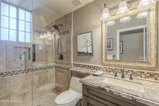 full bath with toilet, a shower stall, and visible vents