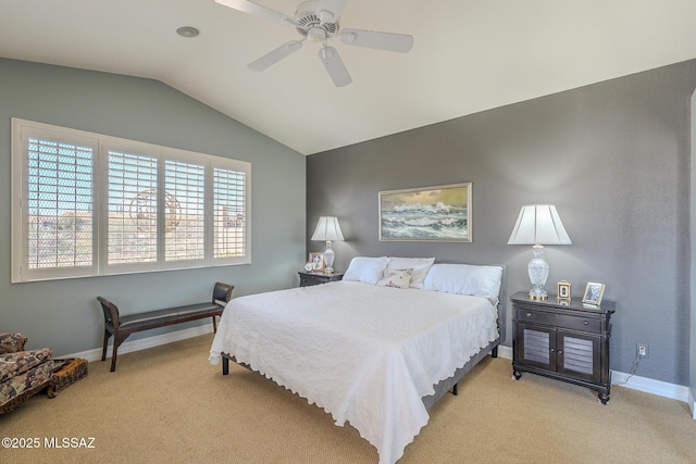 bedroom featuring lofted ceiling, light carpet, and baseboards