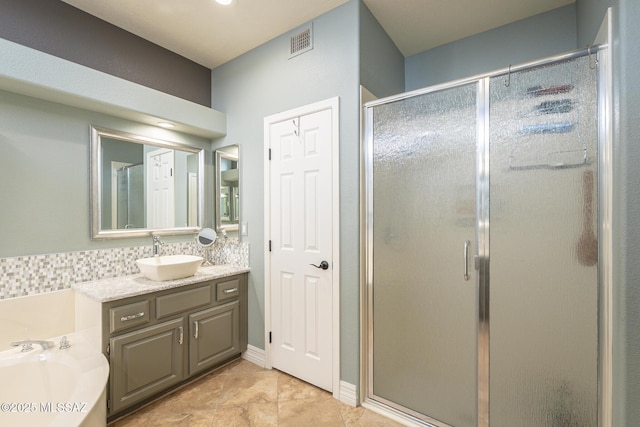 bathroom with a stall shower, visible vents, a garden tub, and vanity