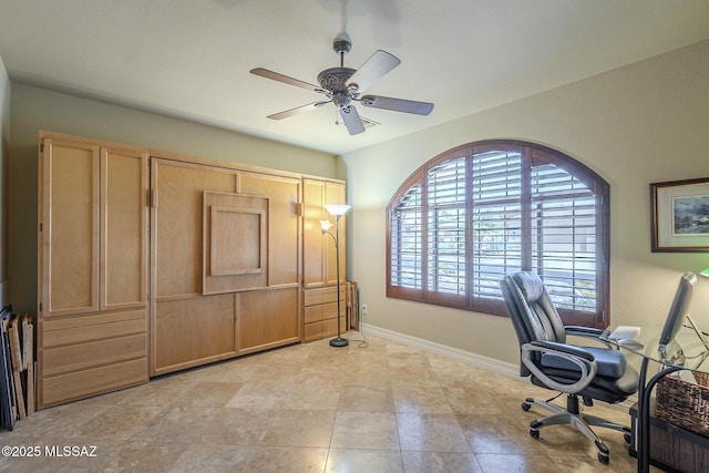 home office with ceiling fan and baseboards