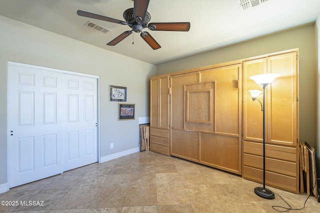 unfurnished bedroom featuring a ceiling fan, visible vents, and baseboards