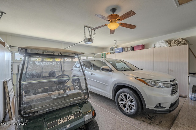 garage with a ceiling fan and a garage door opener