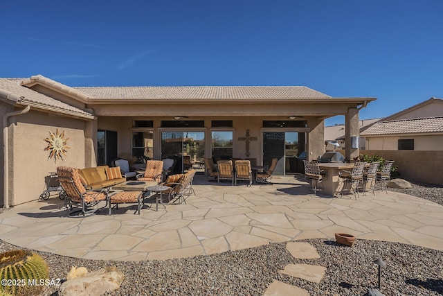 view of patio with a ceiling fan and outdoor dining space