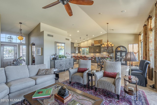 living area featuring high vaulted ceiling, visible vents, and plenty of natural light