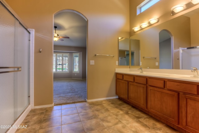 bathroom with ceiling fan, a sink, and a shower with shower door