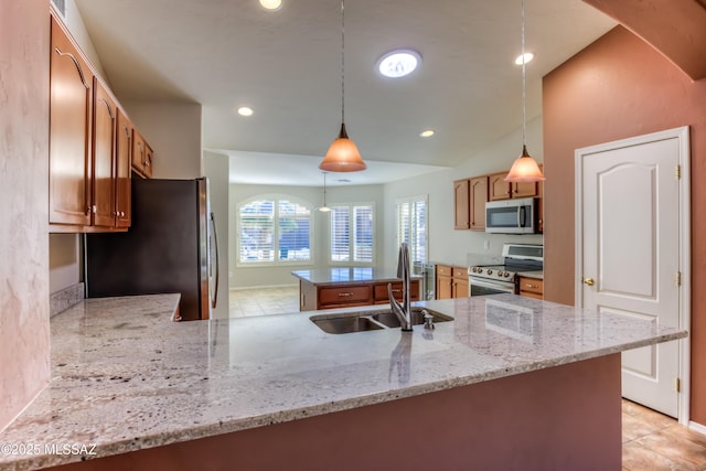 kitchen featuring light stone counters, a center island, recessed lighting, appliances with stainless steel finishes, and a sink