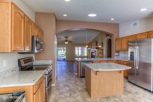 kitchen featuring arched walkways, lofted ceiling, visible vents, appliances with stainless steel finishes, and a peninsula