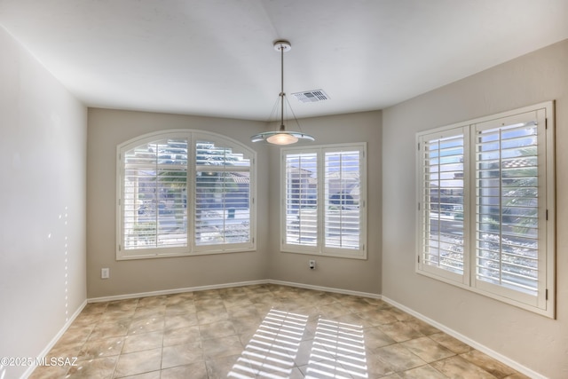 unfurnished dining area with visible vents, baseboards, and light tile patterned floors