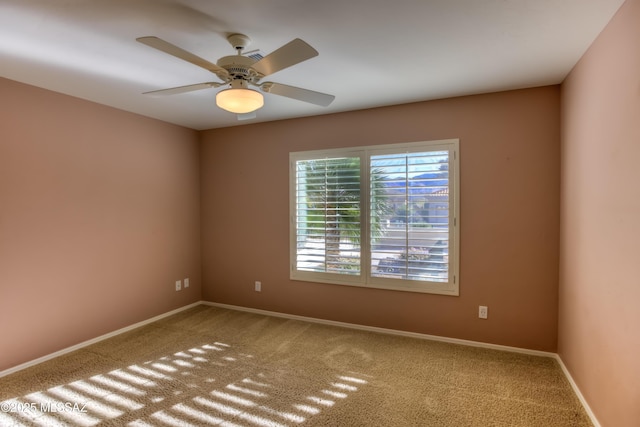 unfurnished room with ceiling fan, baseboards, and carpet flooring