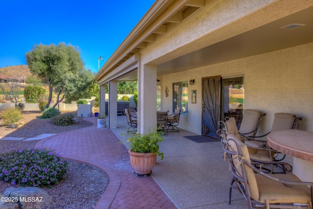 view of patio featuring outdoor dining area