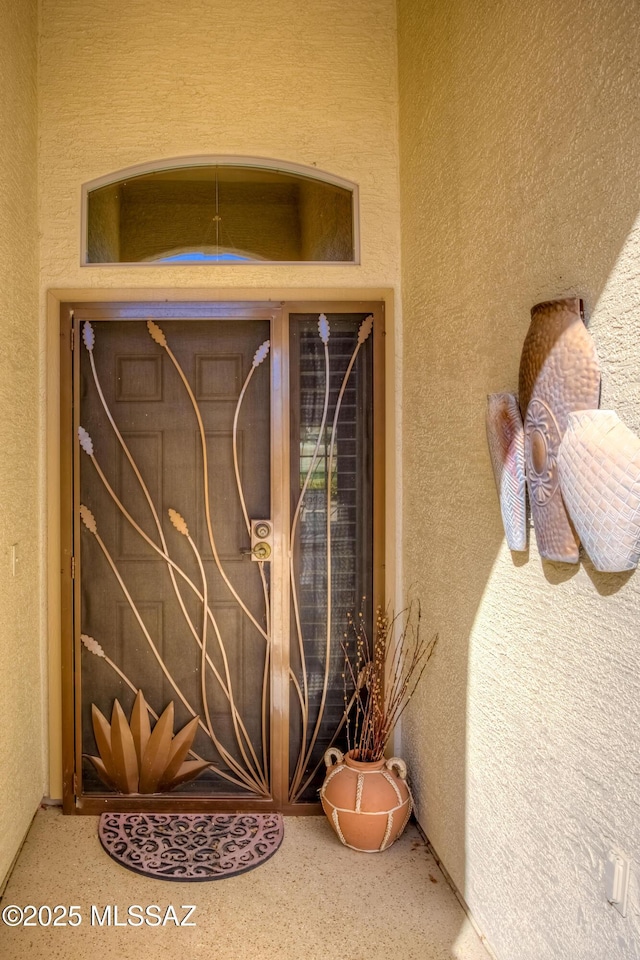 property entrance featuring stucco siding