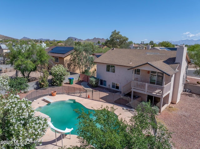 3381 W Calle De La Bajada, Tucson, AZ 85746 - view of swimming pool with a water slide, a fenced backyard, a deck with mountain view, and a patio