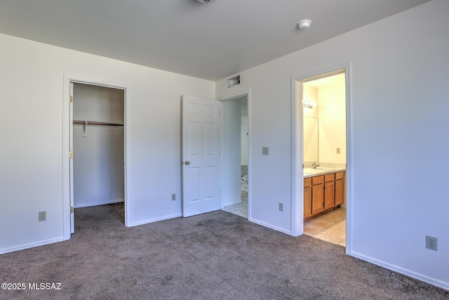 3381 W Calle De La Bajada, Tucson, AZ 85746 - unfurnished bedroom featuring light colored carpet, a spacious closet, a closet, and baseboards