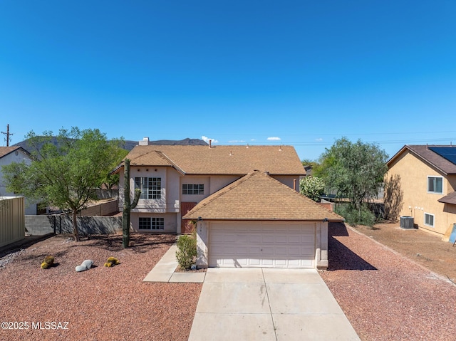 3381 W Calle De La Bajada, Tucson, AZ 85746 - traditional-style house with stucco siding, concrete driveway, fence, a garage, and roof with shingles