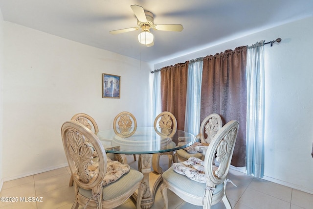 dining space featuring light tile patterned floors and ceiling fan