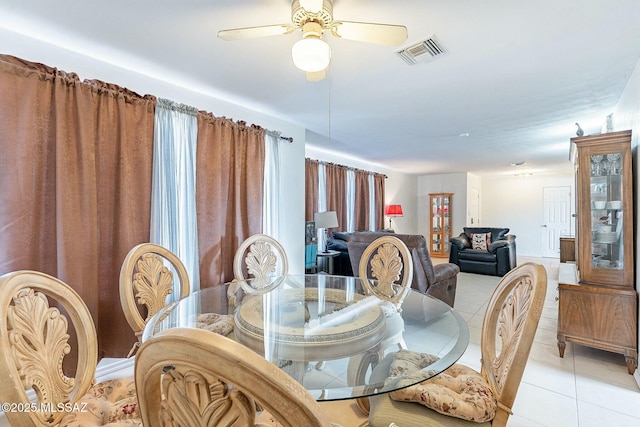 dining area featuring ceiling fan, light tile patterned flooring, and visible vents