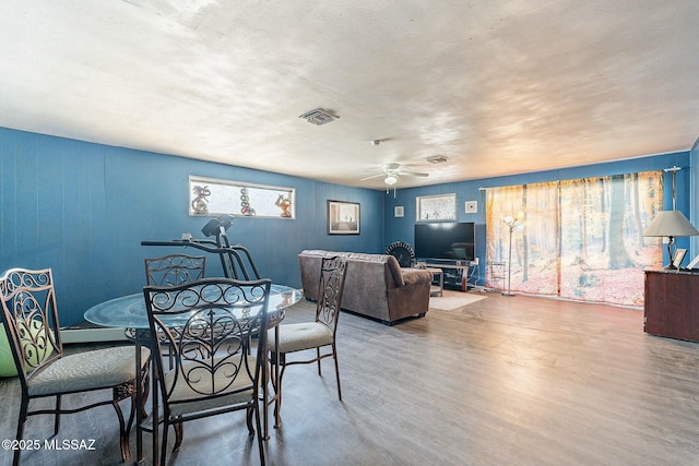 dining room featuring ceiling fan, wood finished floors, and visible vents