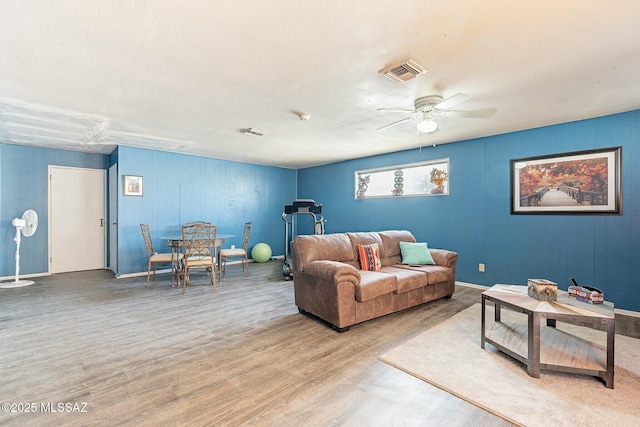 living room featuring visible vents, ceiling fan, and light wood-style flooring