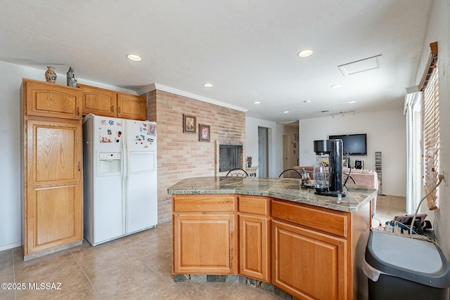 kitchen with open floor plan, white fridge with ice dispenser, brick wall, and recessed lighting