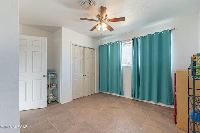 unfurnished bedroom featuring a ceiling fan, a closet, and visible vents