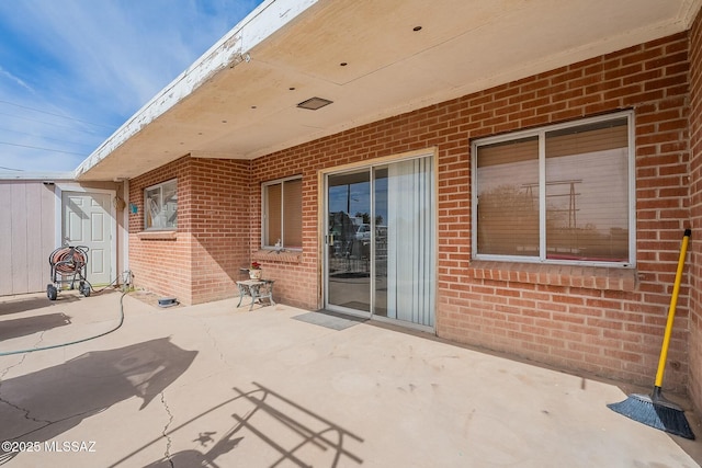 view of patio / terrace featuring a shed and an outbuilding