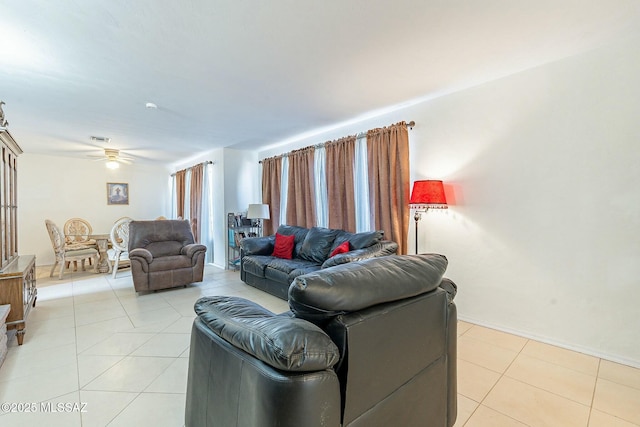 living area featuring a ceiling fan and light tile patterned floors