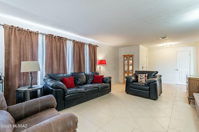 living room featuring light tile patterned floors and visible vents