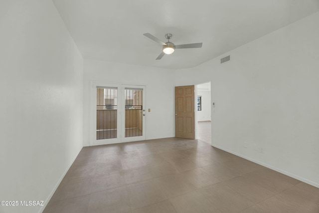 empty room with a ceiling fan, visible vents, and baseboards