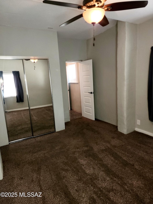 unfurnished bedroom with carpet, a closet, and ceiling fan