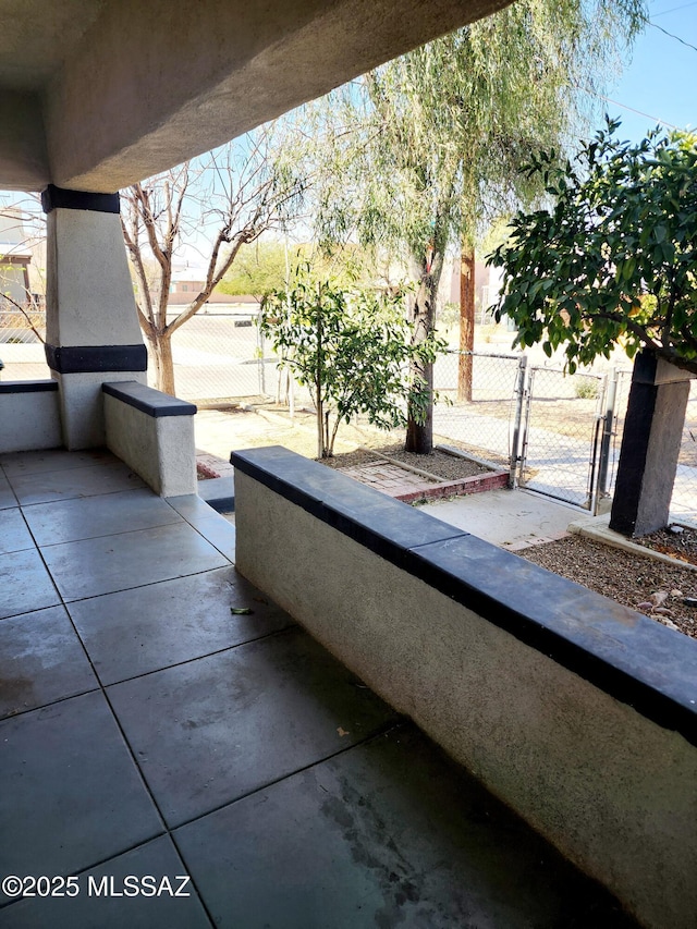 view of patio featuring fence and a gate