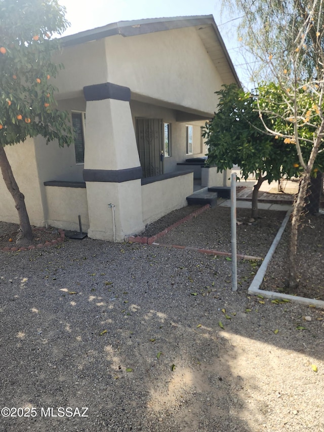 view of side of home with stucco siding