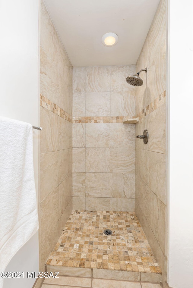 full bath featuring a tile shower