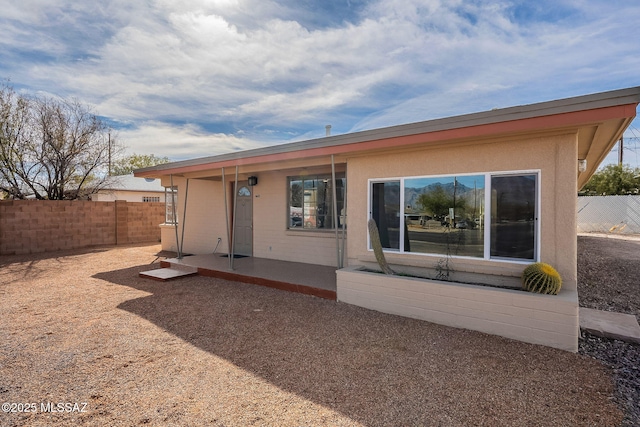 exterior space with fence and stucco siding