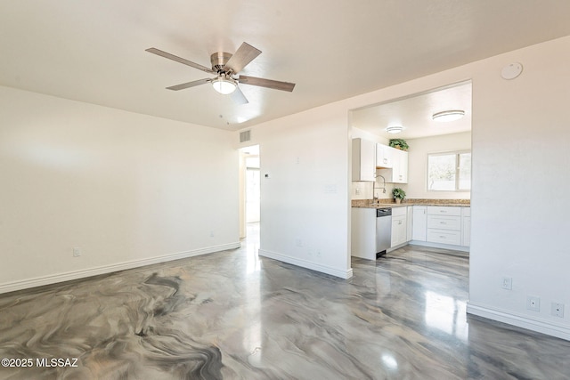 unfurnished living room featuring visible vents, finished concrete floors, a ceiling fan, a sink, and baseboards