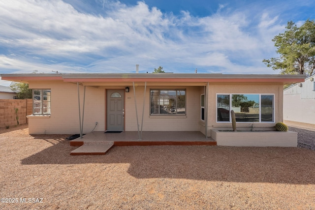 exterior space featuring a porch and fence