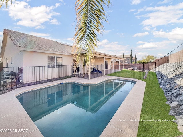 view of swimming pool with a patio, a lawn, a fenced backyard, and a fenced in pool