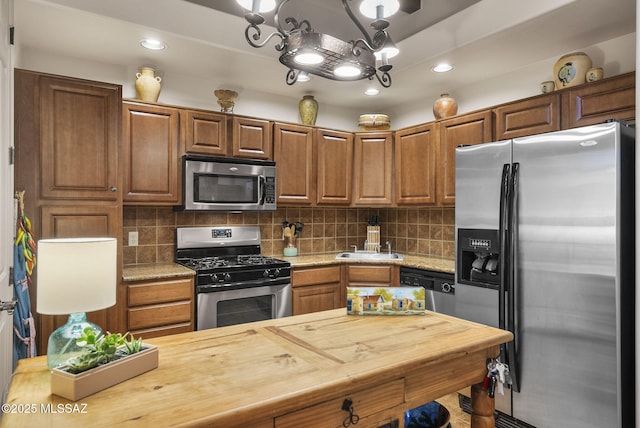 kitchen featuring tasteful backsplash, wood counters, appliances with stainless steel finishes, and recessed lighting