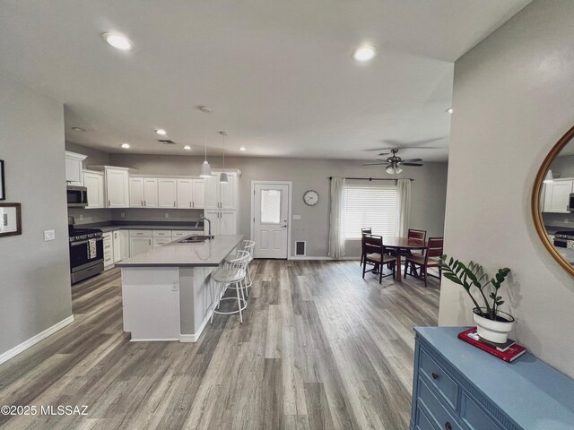 1785 Camilla Cir, Safford, AZ 85546 - kitchen featuring white cabinets, ceiling fan, recessed lighting, wood finished floors, and stainless steel appliances