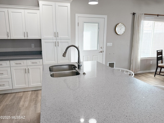 1785 Camilla Cir, Safford, AZ 85546 - kitchen with a sink, light wood finished floors, dark stone countertops, and white cabinetry