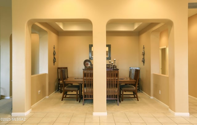 dining space with light tile patterned floors and baseboards