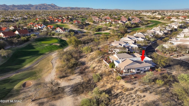 aerial view featuring a residential view, a mountain view, and golf course view